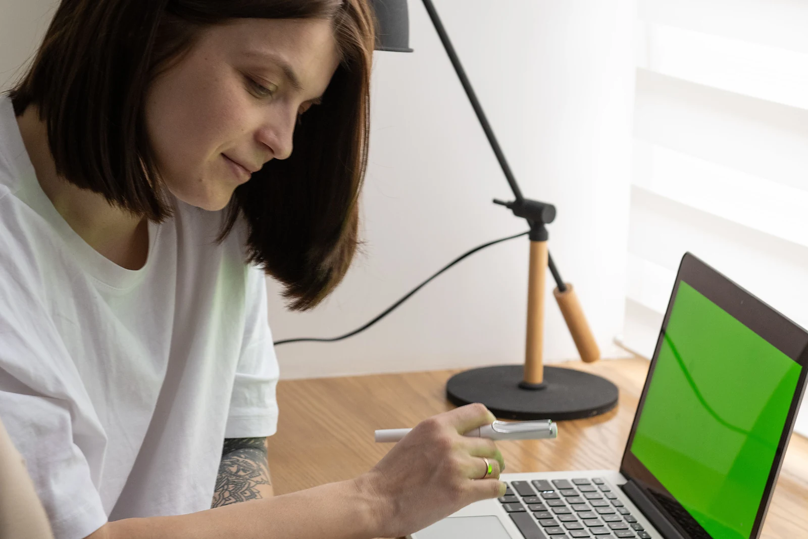 A self-employed professional reviewing financial records on a laptop