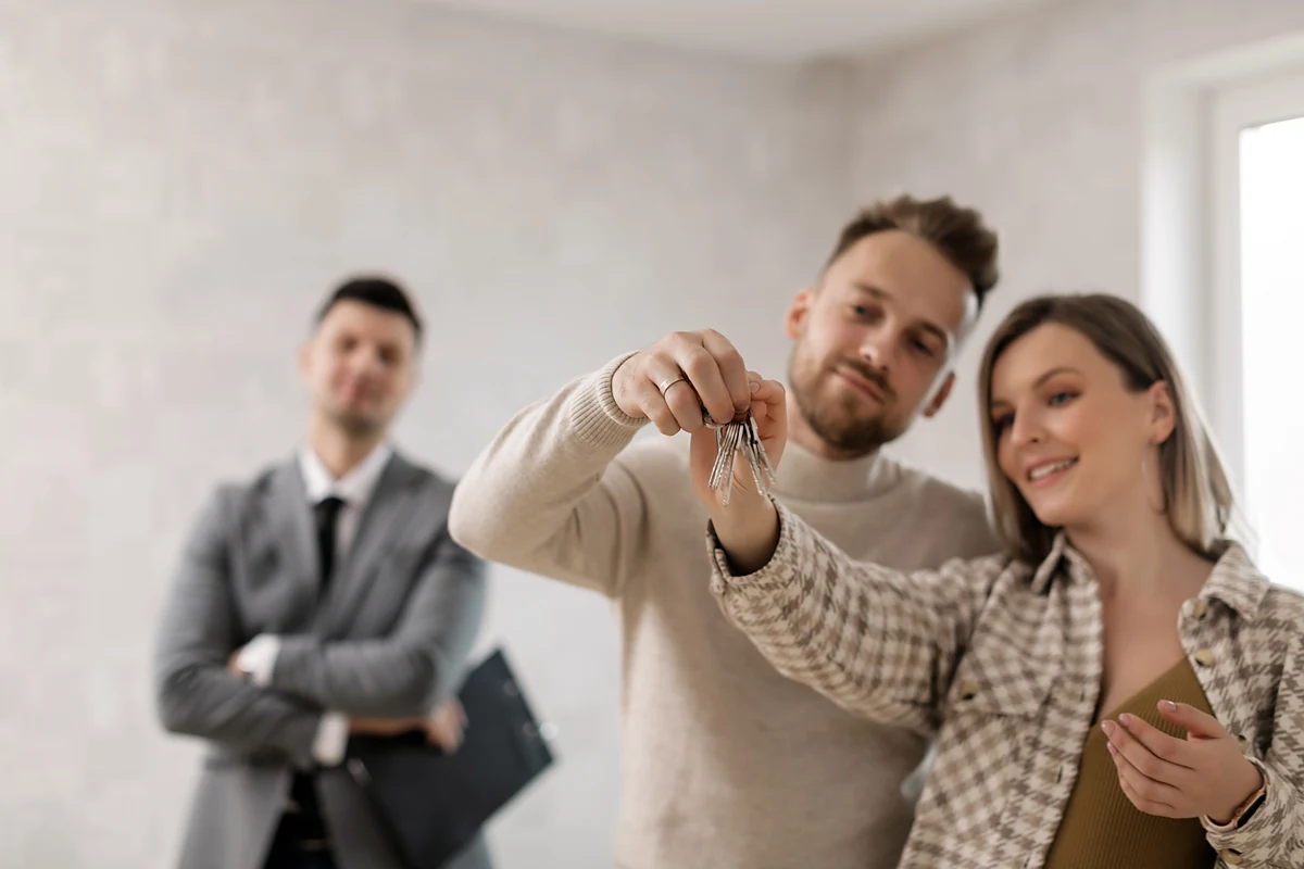 A homebuying couple receiving the keys to their new home