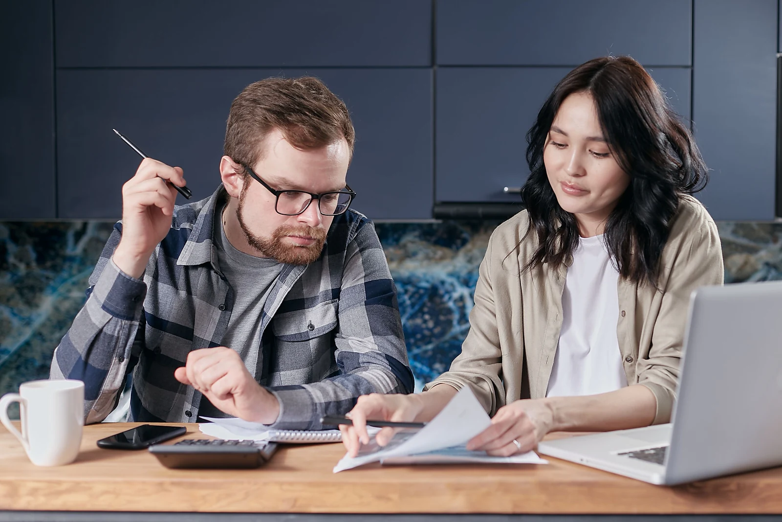 Homeowners reviewing their current mortgage costs and refinance options