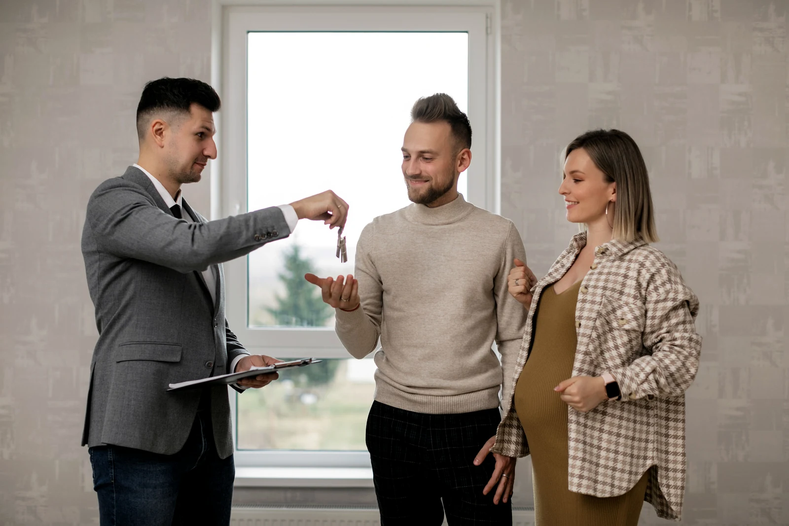 Homebuyers receiving keys from a real estate professional